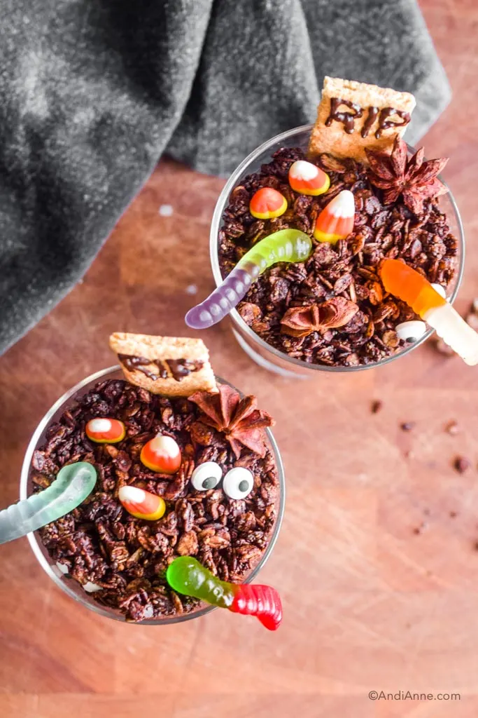 Looking down at the halloween graveyard dirt cups where you can see different types of candies and the chocolate granola base.