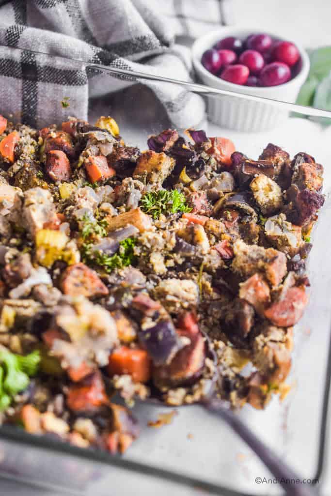 side angle of keto stuffing with bowl of cranberries and kitchen towel in the background