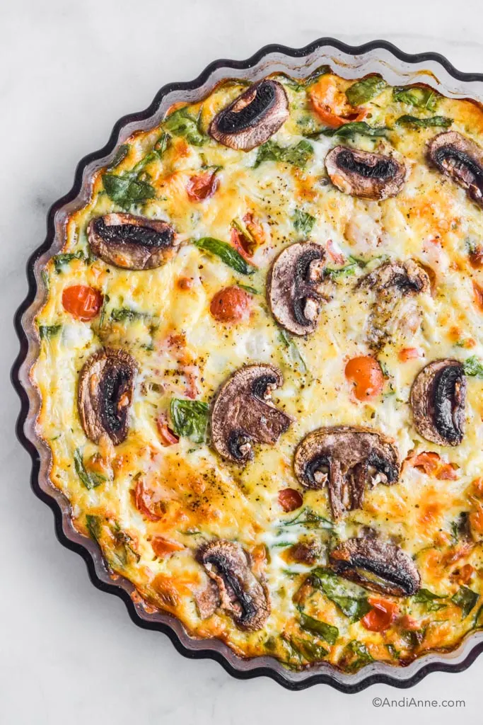 Looking down at vegetable frittata in a glass tart dish
