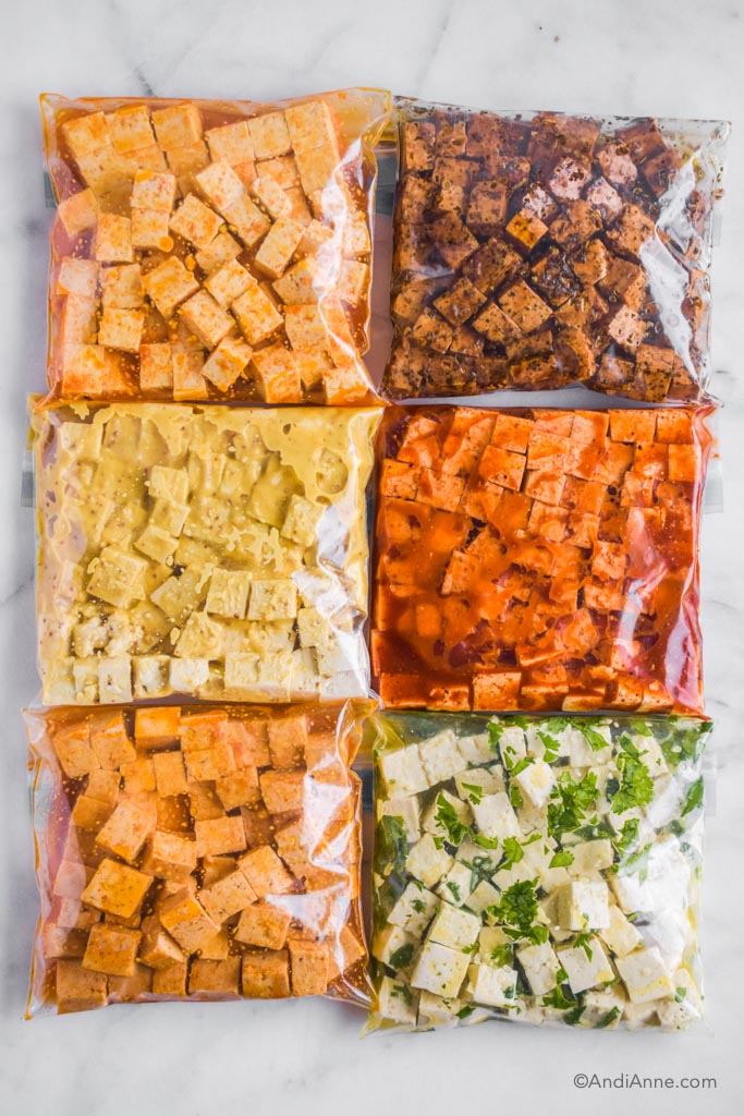 tofu marinades in plastic ziploc bags with six different flavors. Each bag includes sauce with different colors.