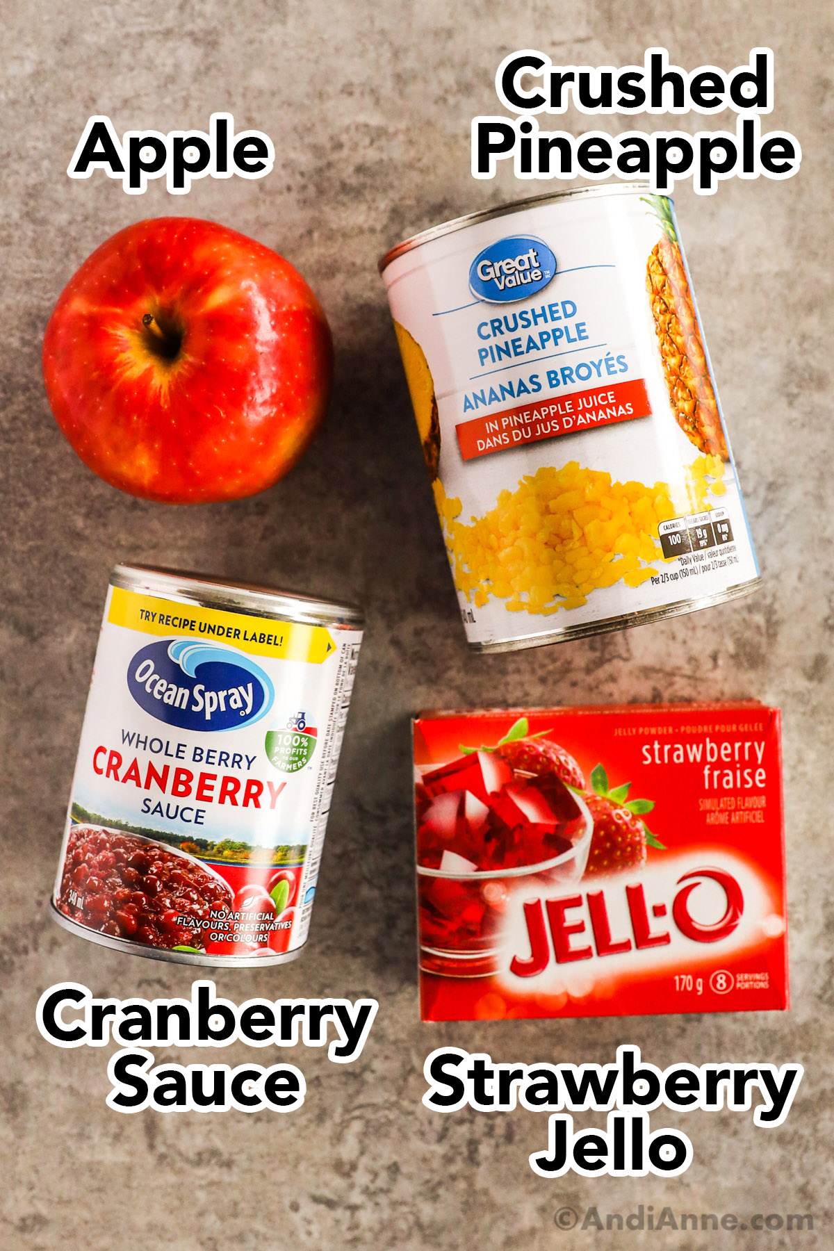 An apple, can of crushed pineapple, canned cranberry sauce, and box of strawberry jello.