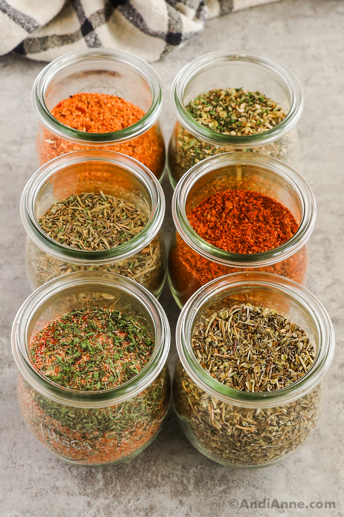 Six small jars with various spice mixes in each.