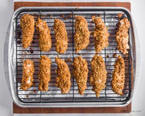 cooked chicken tenders on a baking rack