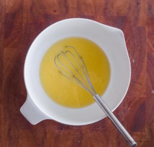 egg and milk with metal whisk