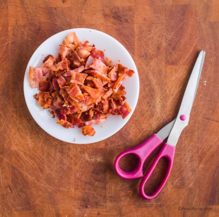 plate with cooked bacon and scissors