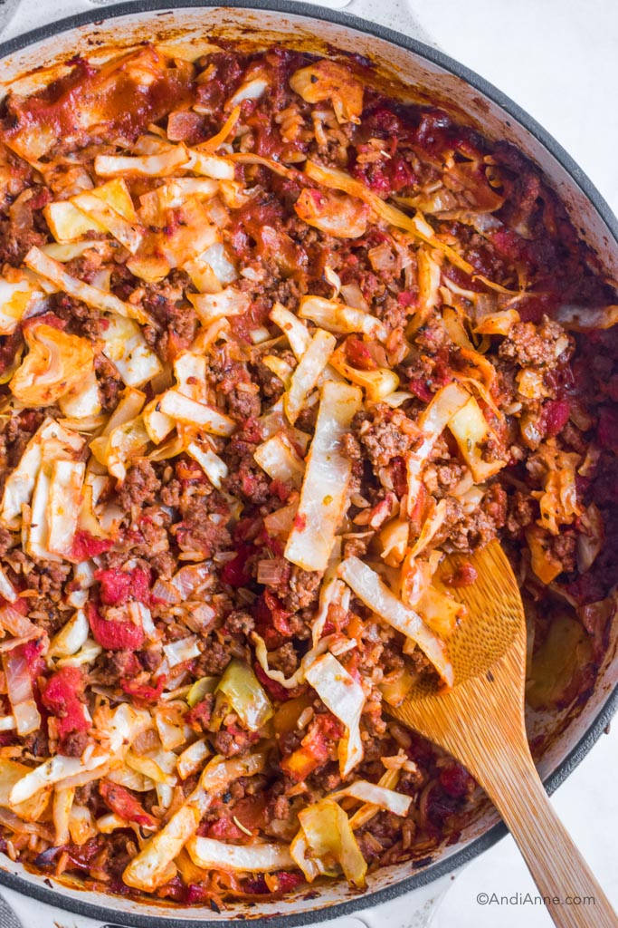 beef rice cabbage casserole in pot with wood spoon