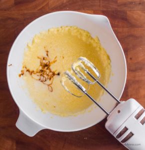 wet batter with molasses in white bowl with hand mixer