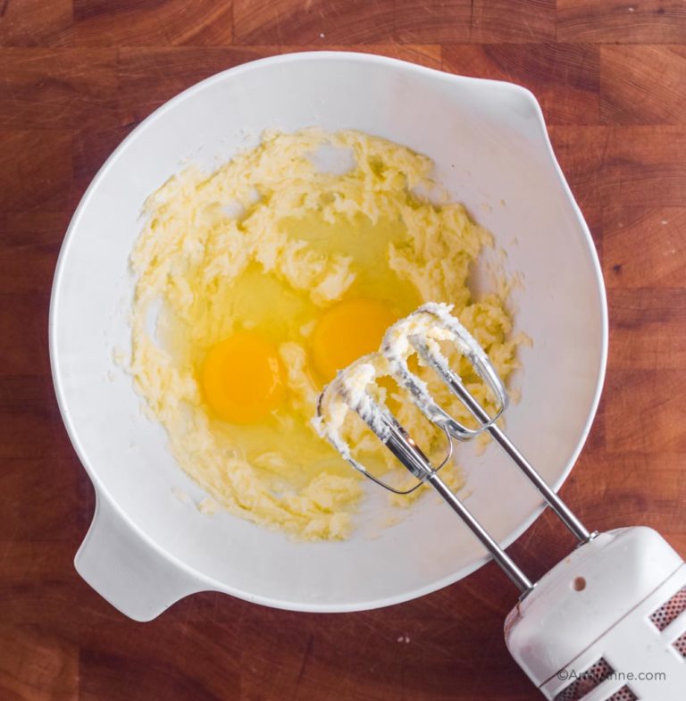 creamed butter in white bowl with eggs