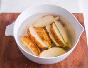 potato wedges in white bowl covered with hot water