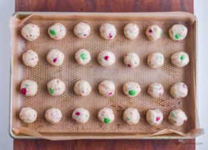 raw cookie dough balls on a baking sheet
