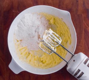 flour with butter mixture in white bowl with hand mixer