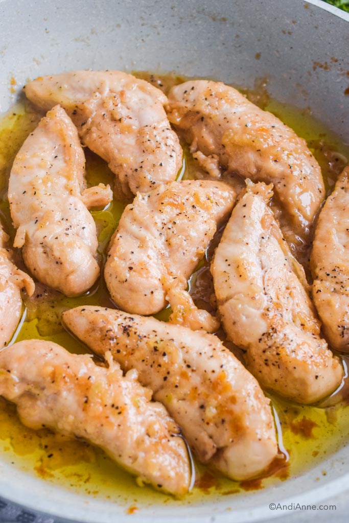 maple lemon garlic chicken tenders close up in a white frying pan