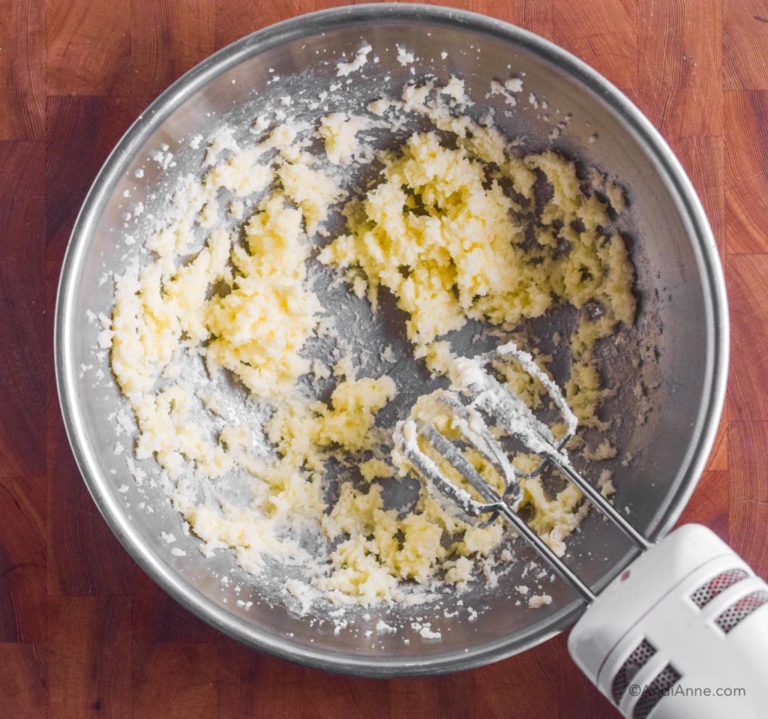 creamed butter and sugar in steel bowl with hand mixer