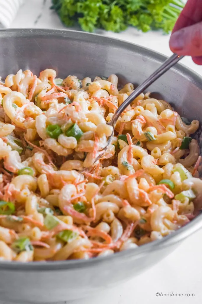 A spoon of creamy macaroni pasta salad. 