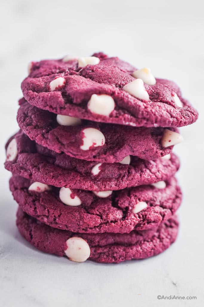 red velvet cake mix cookies with white chocolate chips piled on top of eachother.