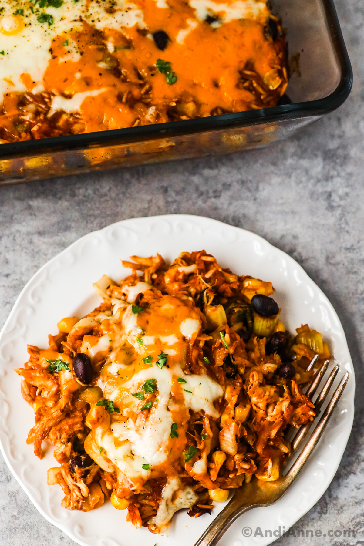 A plate of shredded barbecue chicken casserole recipe with a fork