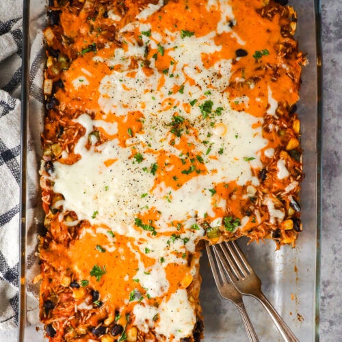Barbecue shredded chicken casserole topped with melted cheese and two forks