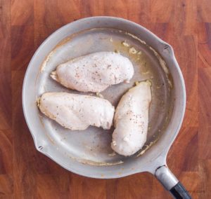 cooked poached chicken in a fyring pan
