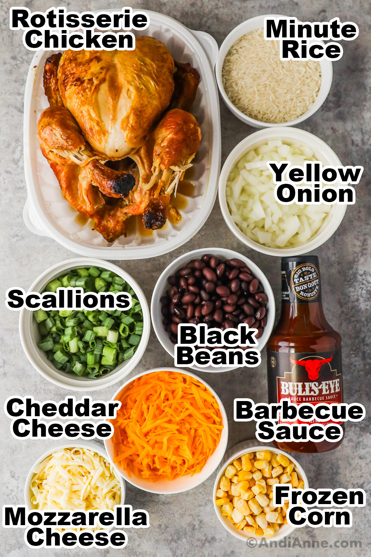 Recipe ingredients in bowls including chopped onion, scallions, black beans, shredded cheese, mozzarella cheese, frozen corn, jar of barbecue sauce, and a rotisserie chicken