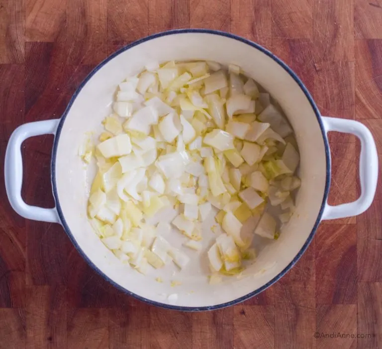 Cooked white onion in a pot.