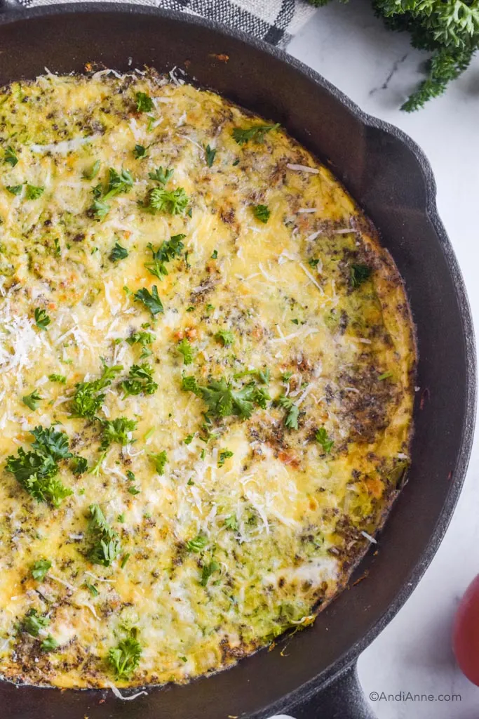 Close up of zucchini parmesan frittata in black skillet