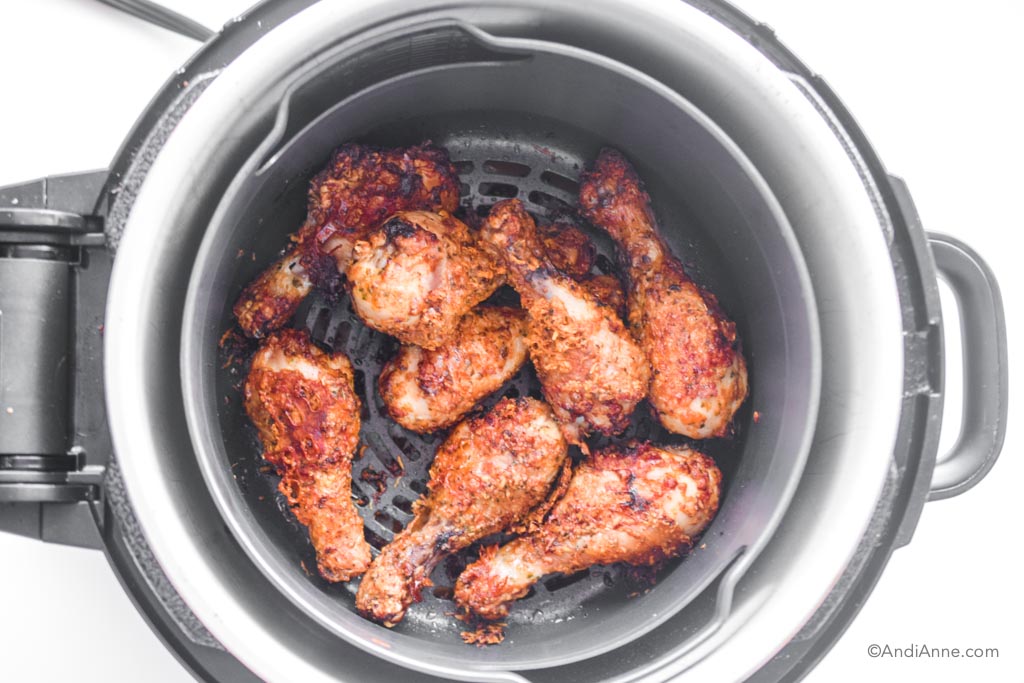 looking down into air fryer with crispy parmesan drumsticks