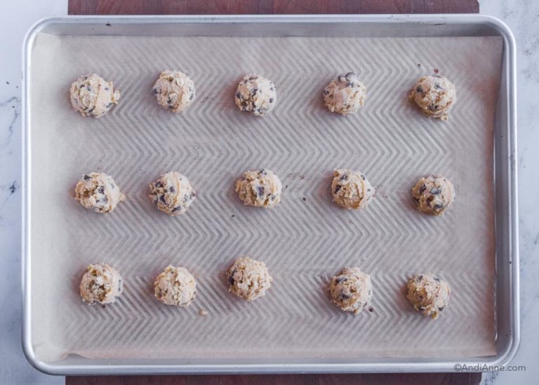 raw cookies on baking sheet with parchment paper