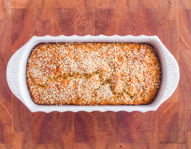 cooked herb bread in white loaf pan