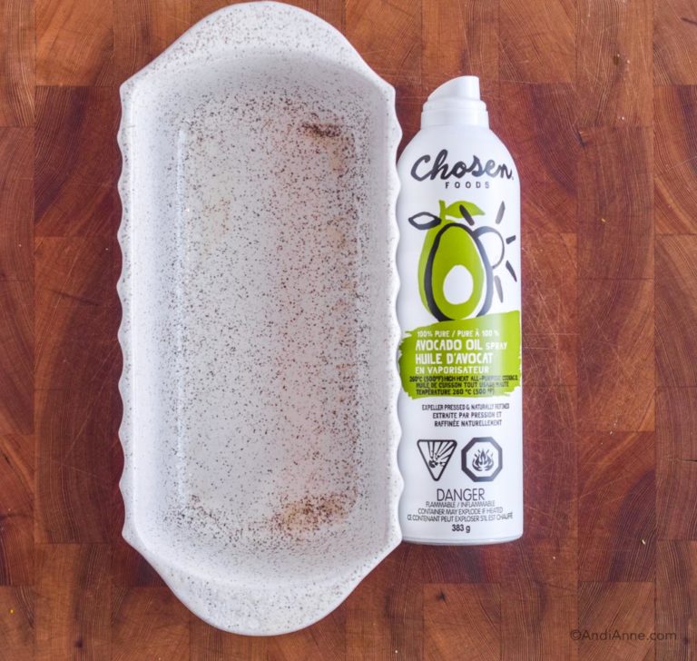 white loaf pan with avocado oil spray beside it