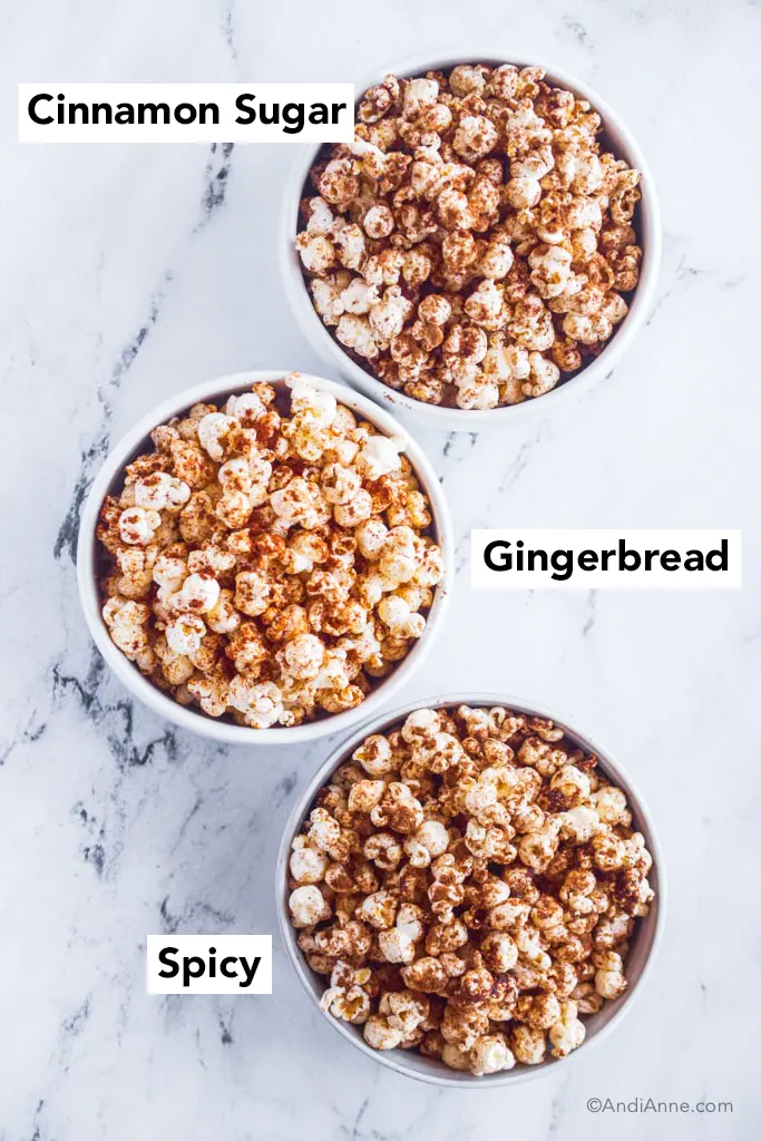 three bowls of popcorn with cinnamon sugar, gingerbread, and spicy seasoning.