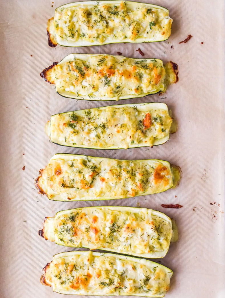 Cooked crab stuffed zucchini boats topped with melted cheese.