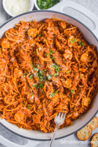 One pot spaghetti in a white round dish with a fork.