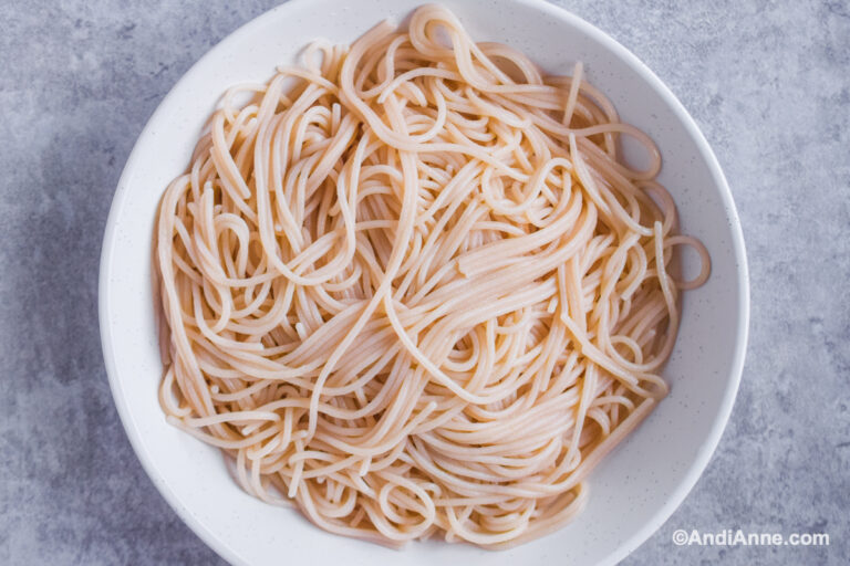 Cooked spaghetti pasta on a white plate.