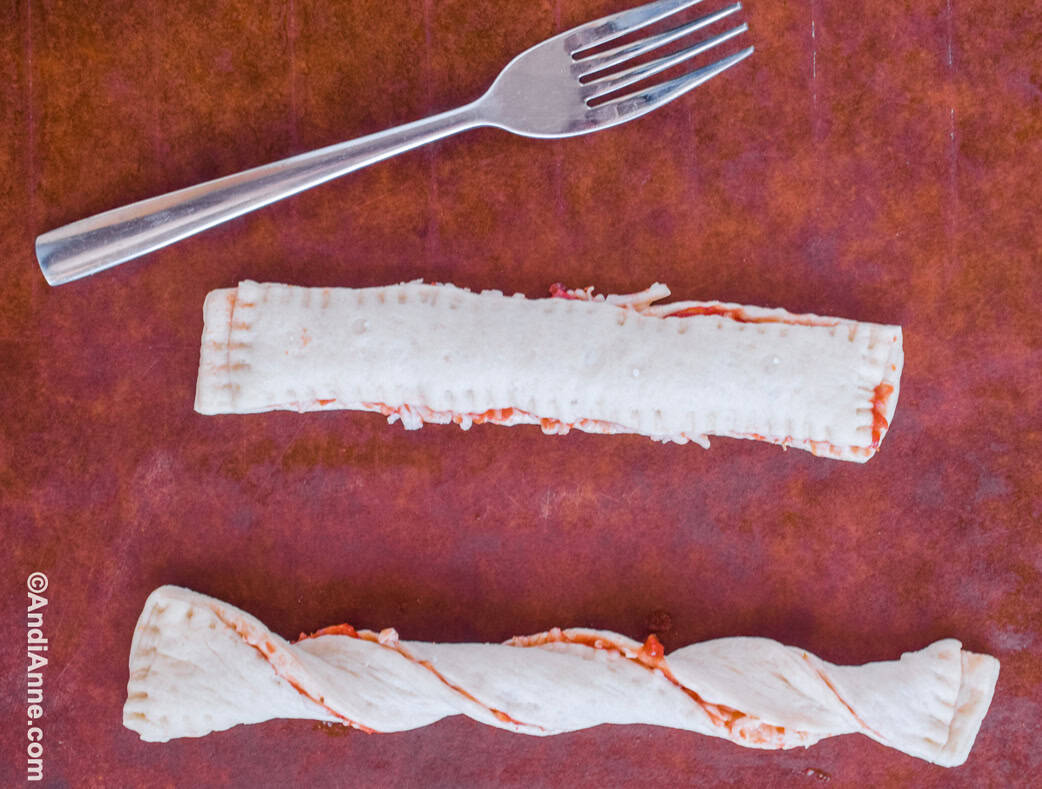 The breadstick edges are pressed together with a fork and then twisted.