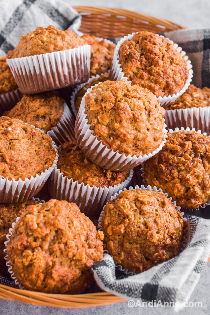 A pile of applesauce oatmeal muffins in a basket.