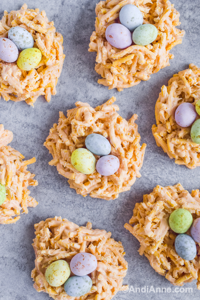 Close up of bird's nest cookies with candy covered chocolate eggs on top.