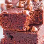 A stack of three brownies topped with chocolate chips. Made without eggs or nuts.