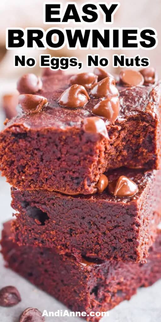 A stack of three brownies topped with chocolate chips. Made without eggs or nuts.