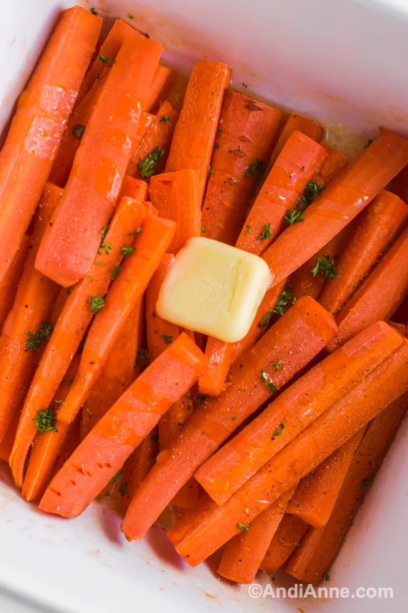 Close up of baked buttered carrots with butter in the center.