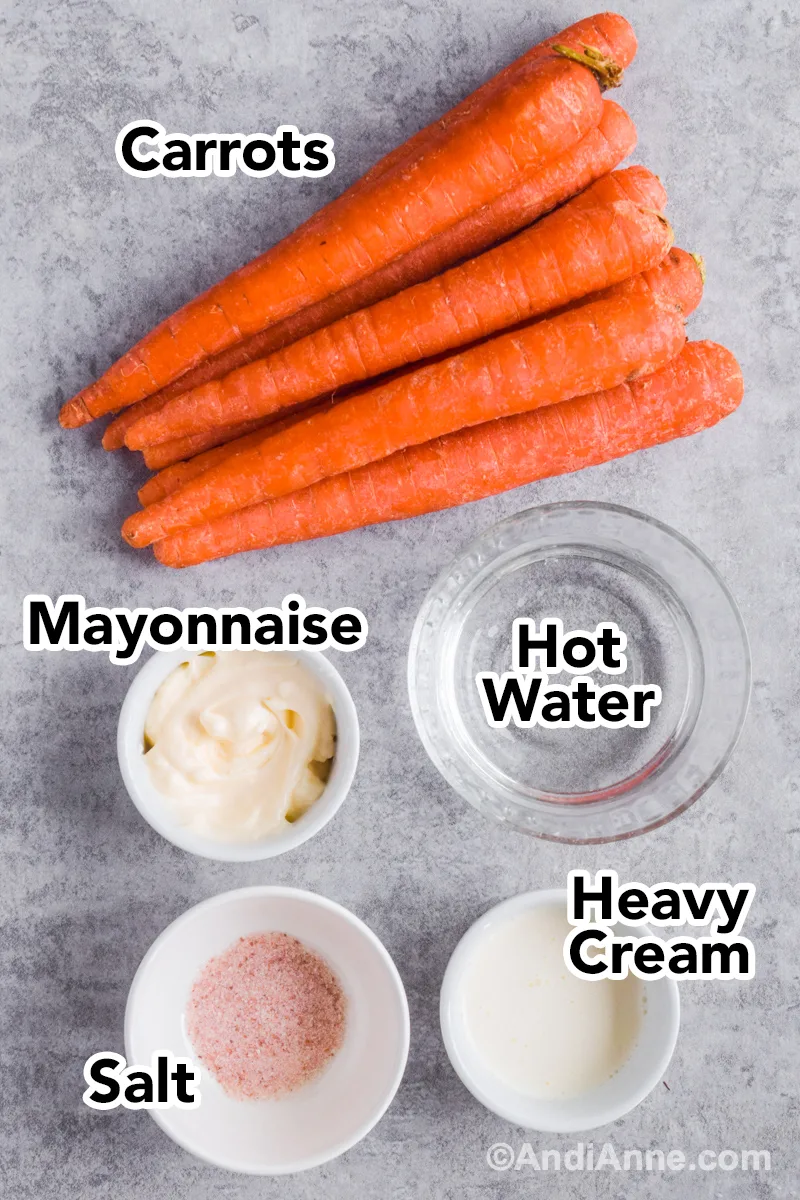 Recipe ingredients on counter including carrots, bowl of mayonnaise, salt, heavy cream and water.