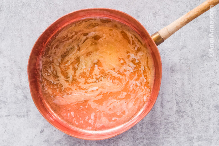 Melted butter in copper pot.