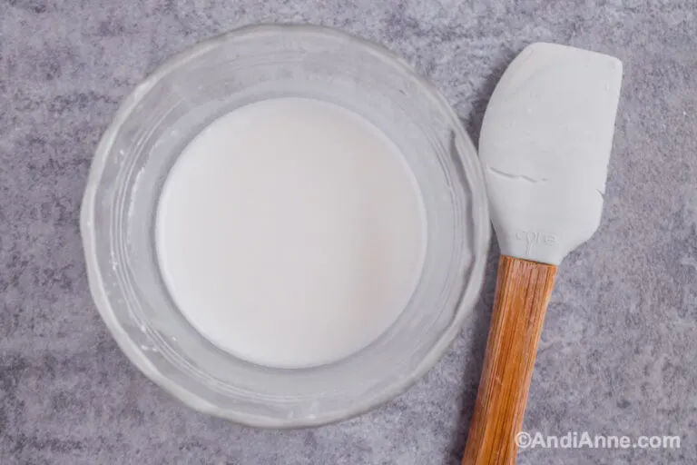 Glass bowl with cornstarch and water and small spatula.
