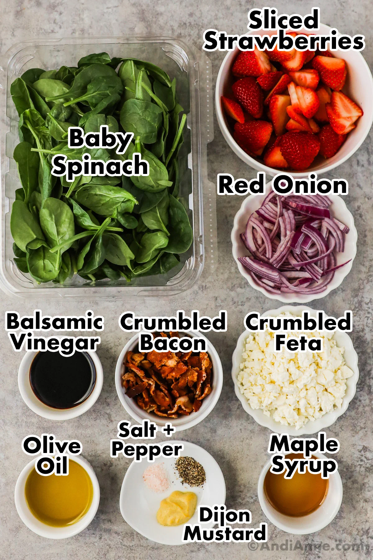 Recipe ingredients including a container of baby spinach, sliced strawberries, sliced red onion, balsamic vinegar, crumbled bacon, crumbled feta, olive oil, and maple syrup.