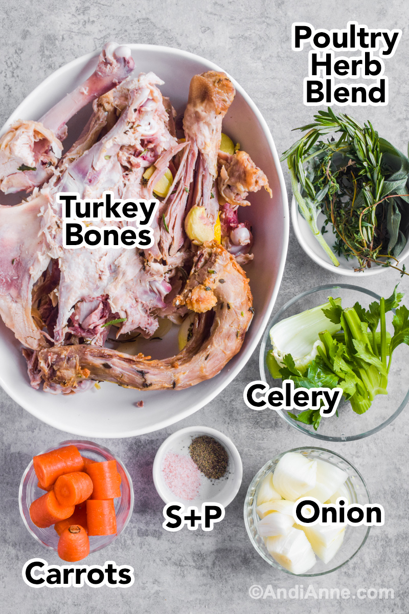 Recipe ingredients including bowl of turkey carcass, fresh herbs, chopped celery, chopped carrots, onion, salt and pepper.