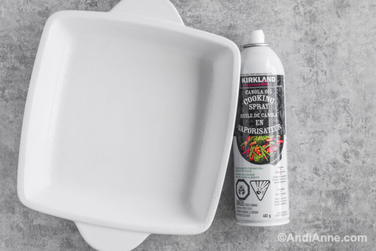 White square casserole dish with cooking spray.