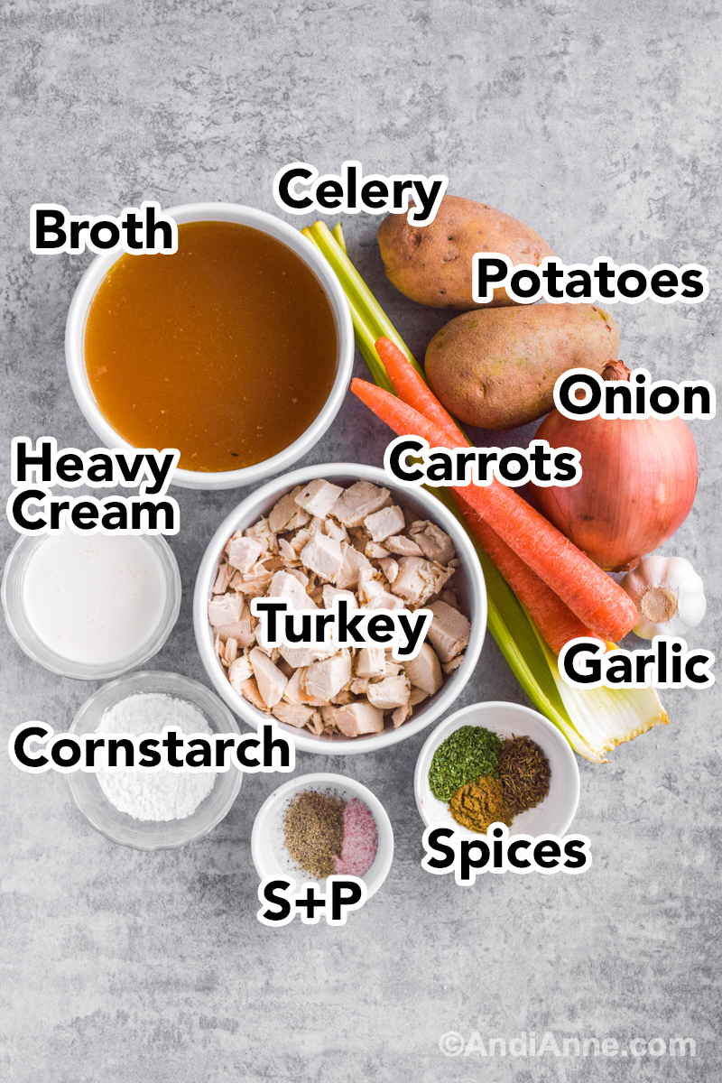 Looking down at ingredients on counter including bowl of broth, potatoes, celery, carrots, turkey, cream, cornstarch, and spices.