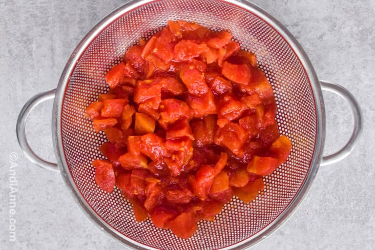 Diced tomatoes in a strainer.