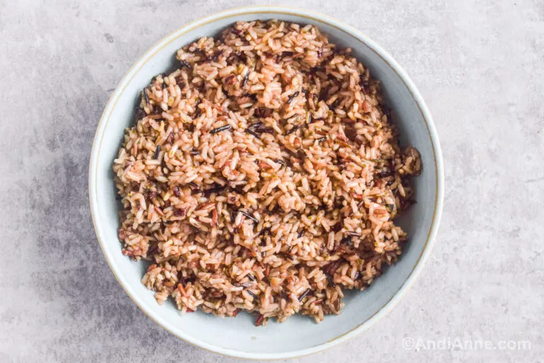 Cooked wild rice and brown rice in a blue bowl.
