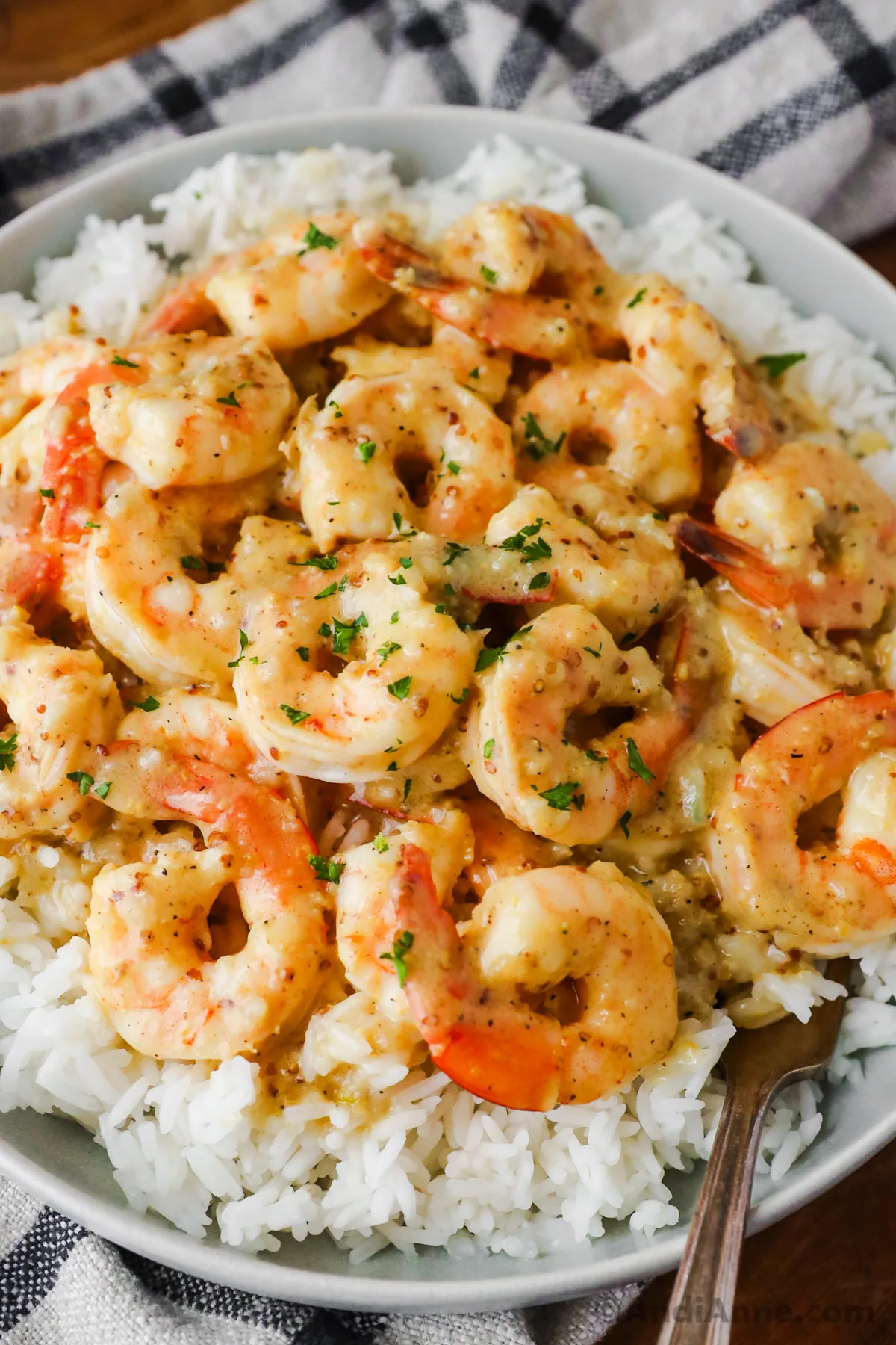 Close up of shrimp covered in honey mustard sauce on a bed of rice.