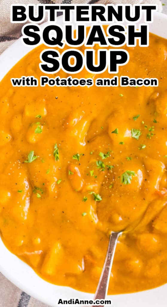 a bowl of butternut squash soup with chopped potatoes and bacon